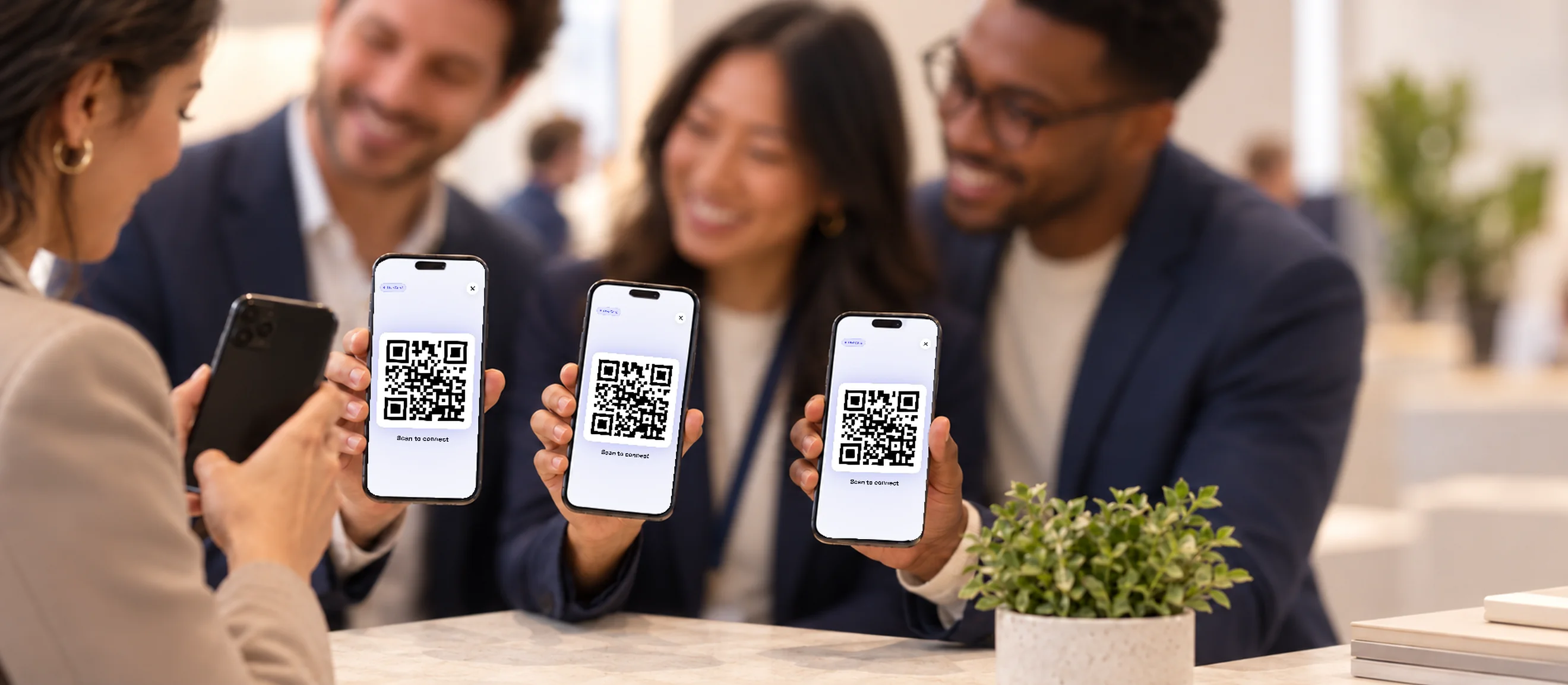 A sales team sharing their digital business cards with visitors at an event.