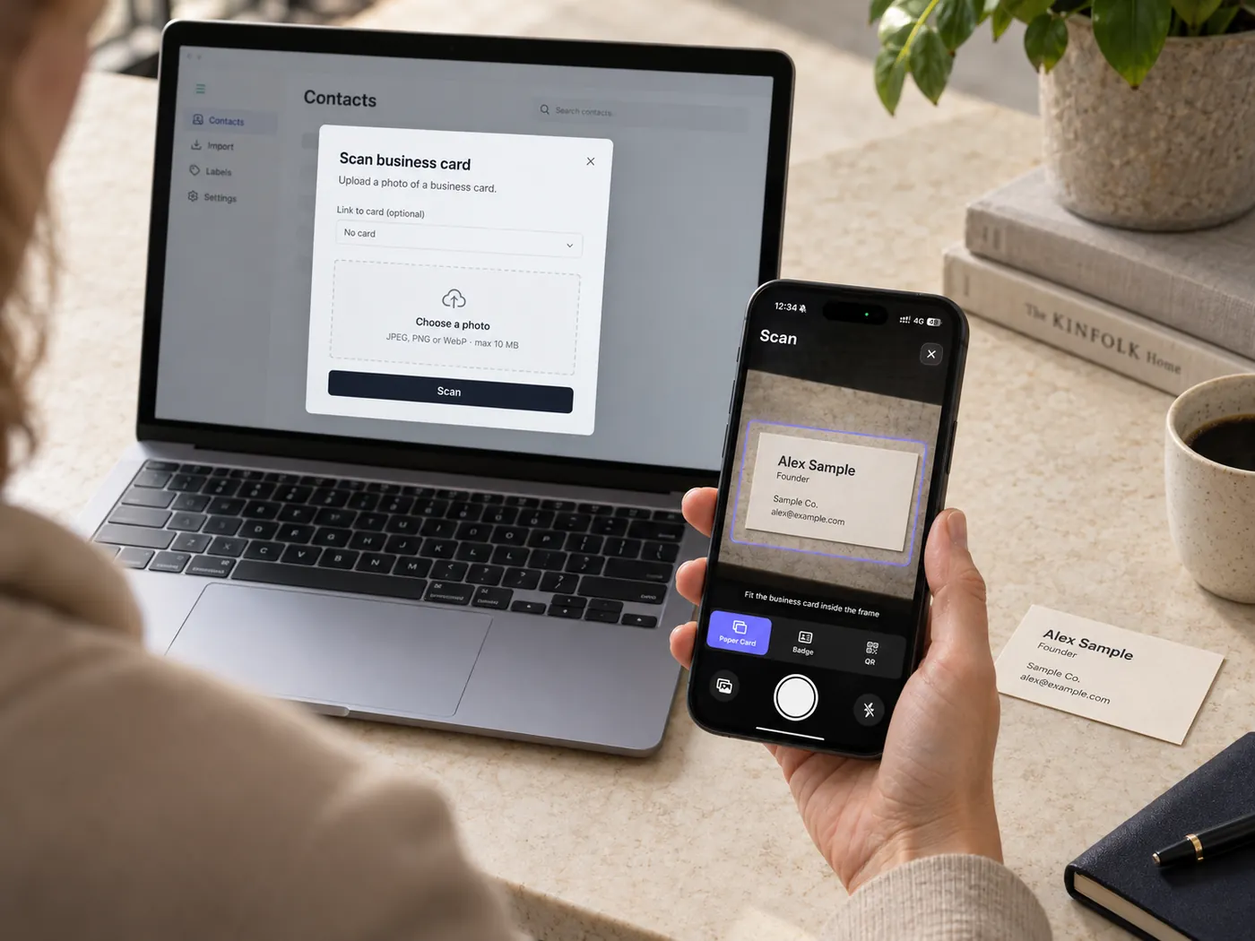 A laptop showing the business card upload dialog beside a phone with the paper card scanner.